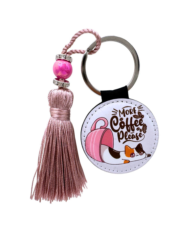Keychain with tassel and 'More Coffee Please' text on a white background
