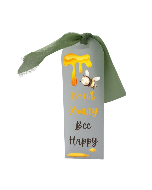 Decorative ribbon with a bee and honey design on a white background