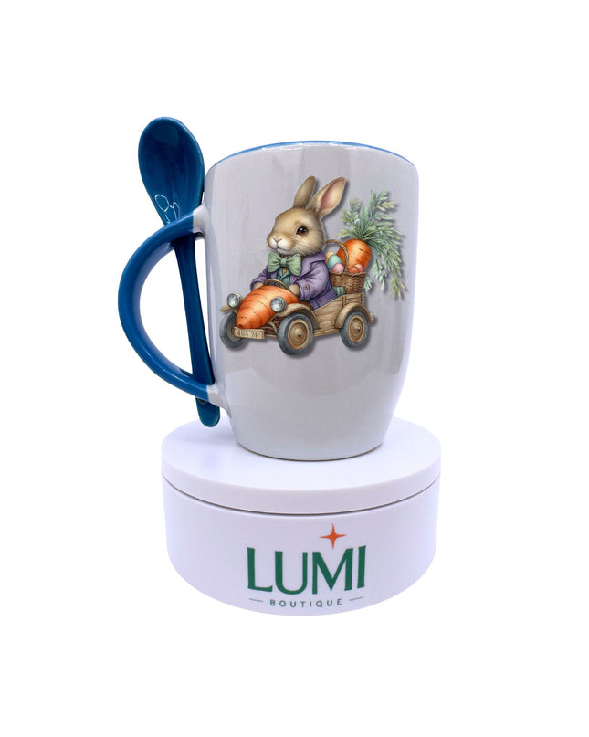 Mug with rabbit design, blue handle, and spoon on a white background with Lumi Boutique branding.