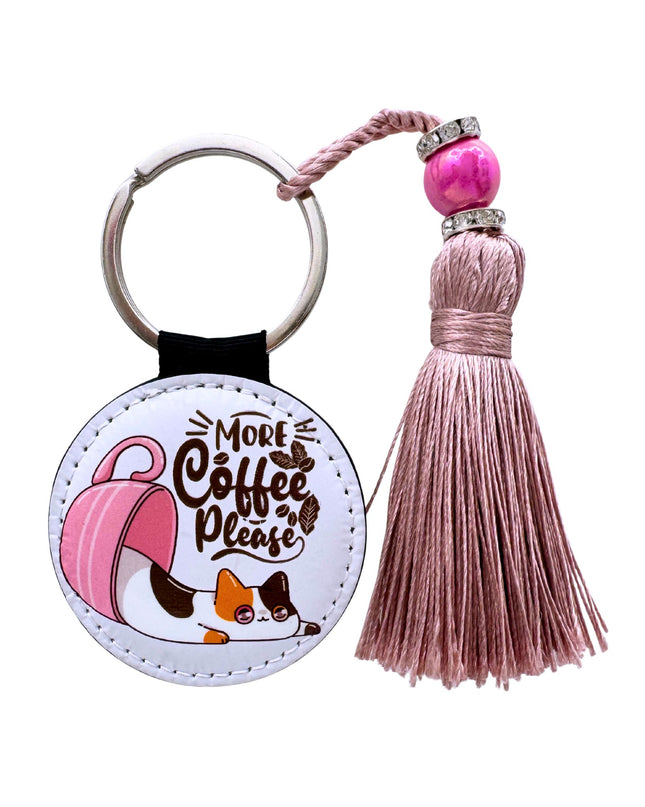 Keychain with tassel featuring a dog illustration and text 'More Coffee Please' on a white background.