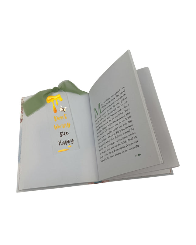 Open book with text and a small illustration on a white background