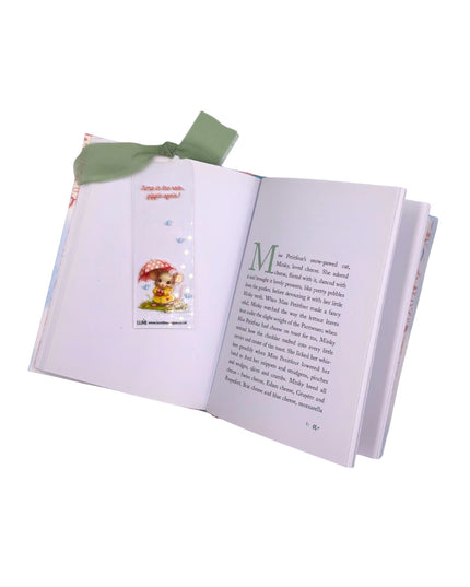 Open book with a bookmark and a small illustration on a white background