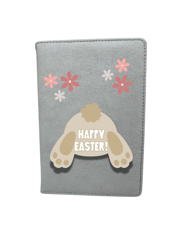 notebook with a bunny paw print and 'Happy Easter!' text on a white background
