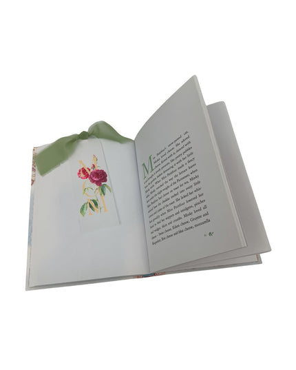 Open book with floral illustration on a white background