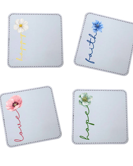 Set of four coasters with floral designs and text on a light blue background