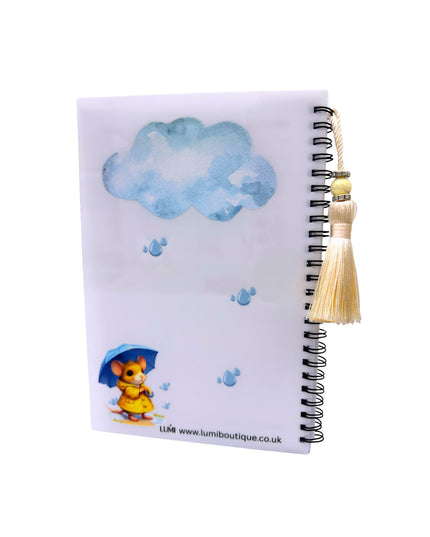 Notebook with a mouse holding an umbrella and cloud design on a white background