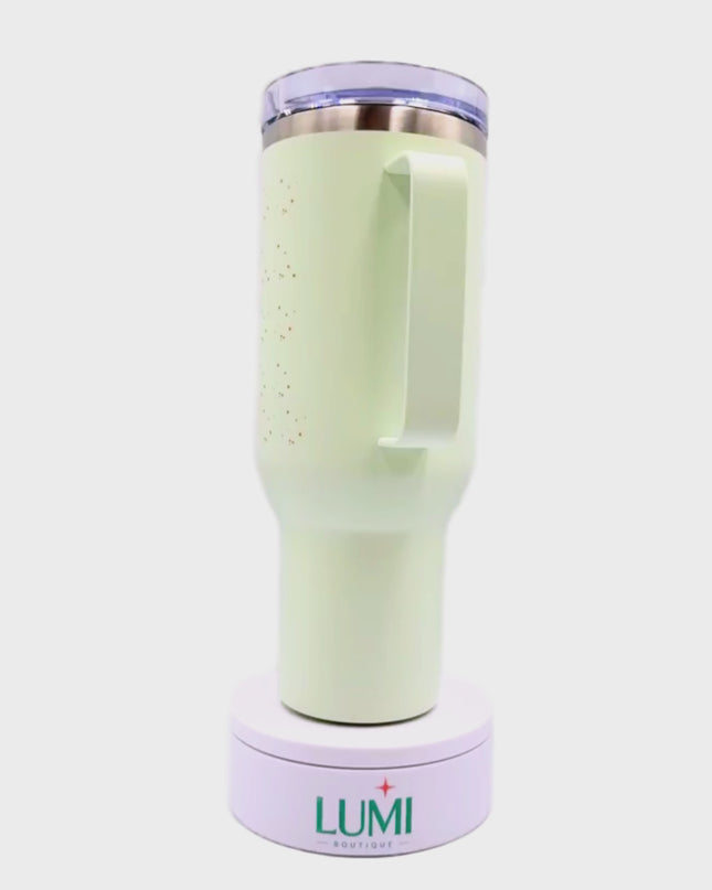 Light green tumbler with text and a flower design 